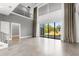 Bright living room featuring high ceilings, oversized windows, and modern tile flooring and staircase at 4047 Isabella Cir, Windermere, FL 34786