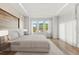 Bright, spacious main bedroom with large windows, a tray ceiling, and modern furnishings for a relaxing atmosphere at 4047 Isabella Cir, Windermere, FL 34786