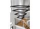 A modern staircase has an interesting lighting fixture and dark metal spindles at 4047 Isabella Cir, Windermere, FL 34786