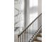 Staircase features wood stairs, black iron railings, and a view of marble fireplace at 4047 Isabella Cir, Windermere, FL 34786