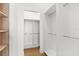 Spacious walk-in closet with adjustable shelving and wooden floors for optimal storage in home at 4047 Isabella Cir, Windermere, FL 34786