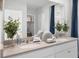 Bright bathroom with double vanity sinks, a large mirror, and decorated with plants and soap at 408 Taylor Groves Dr, Lake Wales, FL 33853