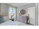 Comfortable bedroom featuring a beach-themed decor, dresser, and natural light from the window at 408 Taylor Groves Dr, Lake Wales, FL 33853
