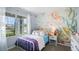 A charming bedroom with fun mermaid wallpaper and a twin-sized bed at 408 Taylor Groves Dr, Lake Wales, FL 33853