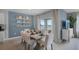The dining area has views of the exterior and a table set for six at 408 Taylor Groves Dr, Lake Wales, FL 33853
