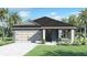 Charming single-Gathering home with a two-car garage, lush lawn, and tropical landscaping at 408 Taylor Groves Dr, Lake Wales, FL 33853