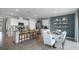 Open-concept living space with dining area, kitchen island, and comfortable seating, perfect for gatherings at 408 Taylor Groves Dr, Lake Wales, FL 33853
