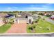 An aerial view of a house with a brick driveway, two car garage and landscaping at 428 Bel Air Way, Kissimmee, FL 34759