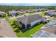 Aerial view of a well-maintained home with solar panels, lush lawn and screened in lanai at 428 Bel Air Way, Kissimmee, FL 34759