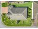 A high angle, full view, showcasing the home's roof, landscaping, and surrounding neighborhood at 428 Bel Air Way, Kissimmee, FL 34759