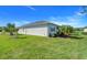 Grassy backyard featuring a screened-in lanai and tasteful landscaping at 428 Bel Air Way, Kissimmee, FL 34759