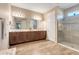 Spacious bathroom with a double sink vanity, framed mirror and a glass-enclosed shower at 428 Bel Air Way, Kissimmee, FL 34759