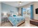 Serene bedroom with a plush bed, blue accents, and ample natural light from a large window at 428 Bel Air Way, Kissimmee, FL 34759