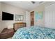Cozy bedroom featuring a comfortable bed, neutral walls, and an en suite bathroom with modern fixtures at 428 Bel Air Way, Kissimmee, FL 34759
