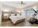Bright bedroom with a neutral color palette, a ceiling fan and a modern stationary bike at 428 Bel Air Way, Kissimmee, FL 34759