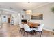 Formal dining room with a wood table, elegant chandelier, and neutral decor with an open view at 428 Bel Air Way, Kissimmee, FL 34759