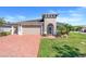 Charming home featuring a two-car garage, brick driveway, and a neatly landscaped front yard at 428 Bel Air Way, Kissimmee, FL 34759