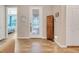 Inviting foyer with decorative glass door, tile flooring, and access to the main bedroom at 428 Bel Air Way, Kissimmee, FL 34759