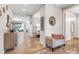 A lovely hallway with stylish decor, leading to the living and dining areas and features easy access to a bathroom at 428 Bel Air Way, Kissimmee, FL 34759