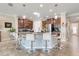 Spacious kitchen features a central island with seating, pendant lights, and stainless steel appliances at 428 Bel Air Way, Kissimmee, FL 34759