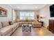 Comfortable living room with neutral walls, sectional sofa, and a round coffee table at 428 Bel Air Way, Kissimmee, FL 34759