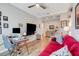 Comfortable living room showcasing a vibrant red sofa and an adjacent home office setup at 428 Bel Air Way, Kissimmee, FL 34759