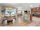 Open-concept living space featuring a kitchen with an island, dining area, and a comfortable living room at 428 Bel Air Way, Kissimmee, FL 34759