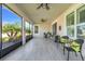 Inviting screened-in lanai featuring tile floors, ceiling fans, and comfortable seating at 428 Bel Air Way, Kissimmee, FL 34759