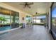 Spacious screened patio with tiled floors, ceiling fans, and sliding glass door access at 428 Bel Air Way, Kissimmee, FL 34759