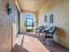 Inviting screened-in front porch featuring brick flooring and charming wicker seating at 428 Bel Air Way, Kissimmee, FL 34759