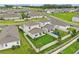 Drone shot displaying a home with a fenced backyard, patio, and well-maintained landscaping at 4338 Davos Dr, Clermont, FL 34711