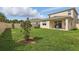 A well-maintained backyard with healthy grass, a patio area, and a privacy fence for serene outdoor living at 4338 Davos Dr, Clermont, FL 34711