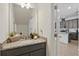 Stylish powder room featuring a granite countertop vanity and easy access to kitchen at 4338 Davos Dr, Clermont, FL 34711