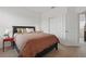 Comfortable bedroom featuring a cozy bed, side tables with lamps, and a closet at 4338 Davos Dr, Clermont, FL 34711