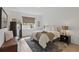 Comfortable bedroom with a queen bed, neutral colors, wood-look flooring, and a large window at 4338 Davos Dr, Clermont, FL 34711