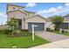 Beautiful two-story home featuring stone accents, a lovely front yard, and brick-paved driveway at 4338 Davos Dr, Clermont, FL 34711