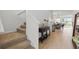 Inviting entryway featuring wood-look tile flooring, staircase, and seamlessly connects to dining area at 4338 Davos Dr, Clermont, FL 34711
