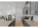 Modern kitchen featuring granite countertops, stainless steel appliances, and open layout to the living room at 4338 Davos Dr, Clermont, FL 34711