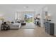 Bright living room featuring wood-style flooring, comfortable seating, and a sliding door to the backyard at 4338 Davos Dr, Clermont, FL 34711