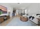 Bright living room with wood-look floors, modern decor and open layout leading to the kitchen at 4338 Davos Dr, Clermont, FL 34711