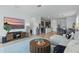 Open-concept living room with modern decor, wood-style flooring, and view of kitchen and dining area at 4338 Davos Dr, Clermont, FL 34711