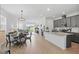 Open-concept area featuring a dining space, granite-counter kitchen and backyard patio access at 4338 Davos Dr, Clermont, FL 34711