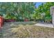 Backyard featuring a large lawn and a basketball hoop, perfect for outdoor activities at 440 E Crystal Lake St, Orlando, FL 32806