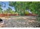 Spacious fenced backyard featuring mature trees, ample space for outdoor activities, and a basketball hoop at 440 E Crystal Lake St, Orlando, FL 32806