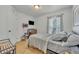 Bedroom with neutral walls, a bed with grey bedding, and a window with patterned curtains at 440 E Crystal Lake St, Orlando, FL 32806