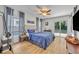 Bright bedroom featuring hardwood floors, a ceiling fan, and a sliding glass door leading to the backyard at 440 E Crystal Lake St, Orlando, FL 32806