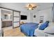 Bedroom showcasing a sliding barn door to the bathroom, with a ceiling fan, and modern decor at 440 E Crystal Lake St, Orlando, FL 32806