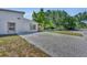 Long brick driveway leading to the home with parking and a side entrance, complemented by lush greenery at 440 E Crystal Lake St, Orlando, FL 32806