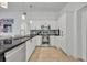 Modern kitchen featuring stainless steel appliances, sleek black countertops and mosaic tile backsplash at 440 E Crystal Lake St, Orlando, FL 32806