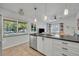 Bright kitchen with stainless steel appliances, a stylish island with bar seating, and tile flooring at 440 E Crystal Lake St, Orlando, FL 32806